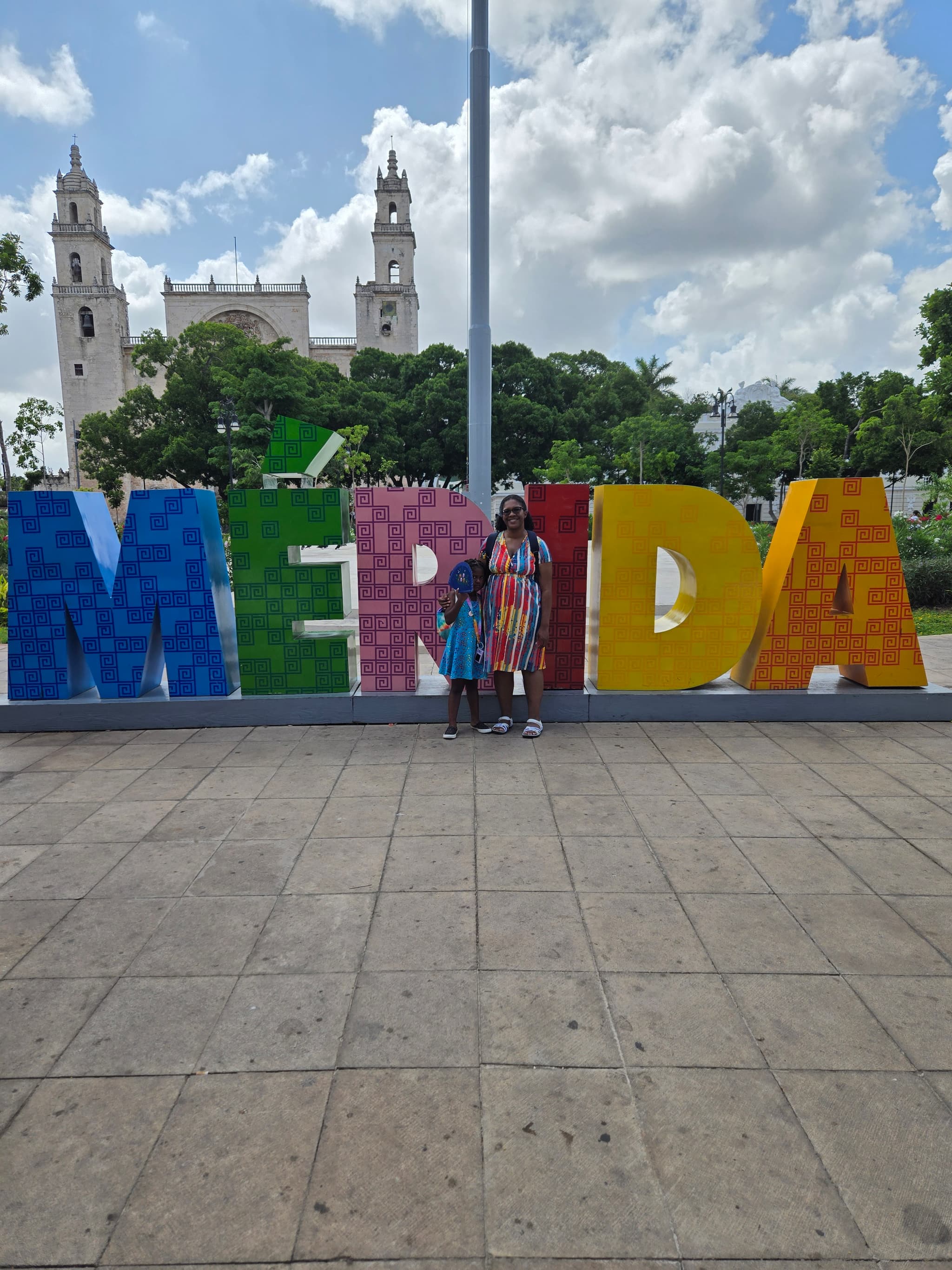 Izzy and Constance in front if giant letters that spell Merida